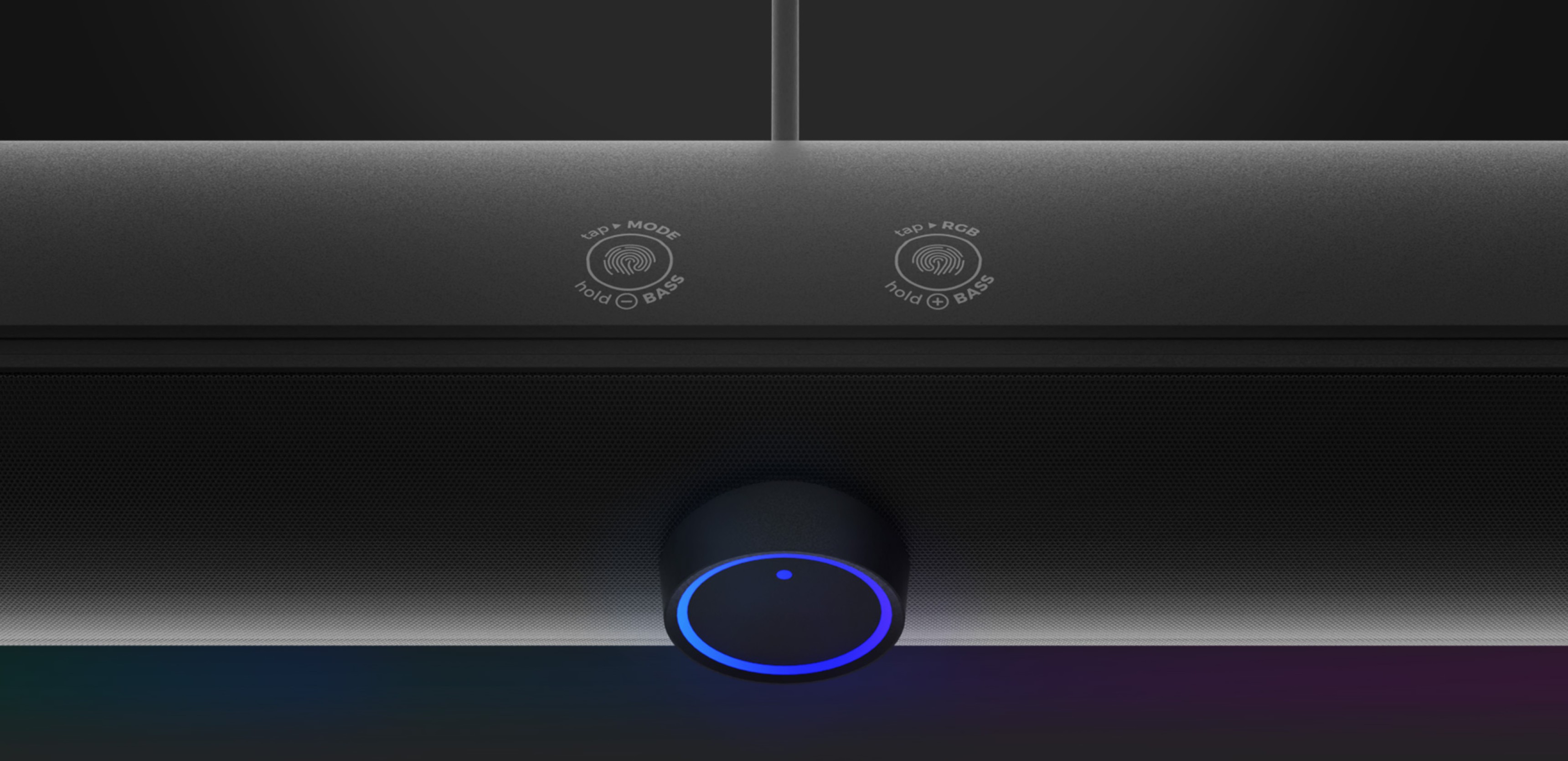 Detail soundbaru Genesis Helium 312BT s ovládacími tlačítky a modrým indikátorem LED